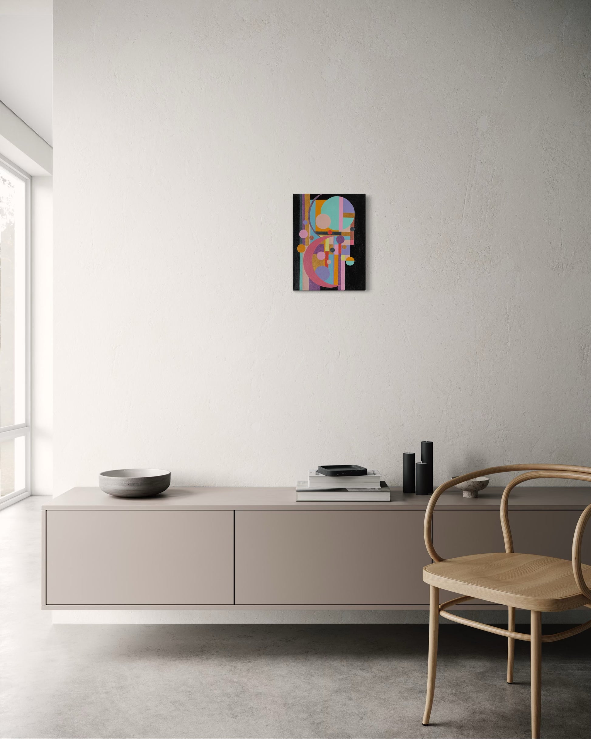 Modern interior with a colorful abstract painting on a white wall, a light-colored cabinet, and a wooden chair.