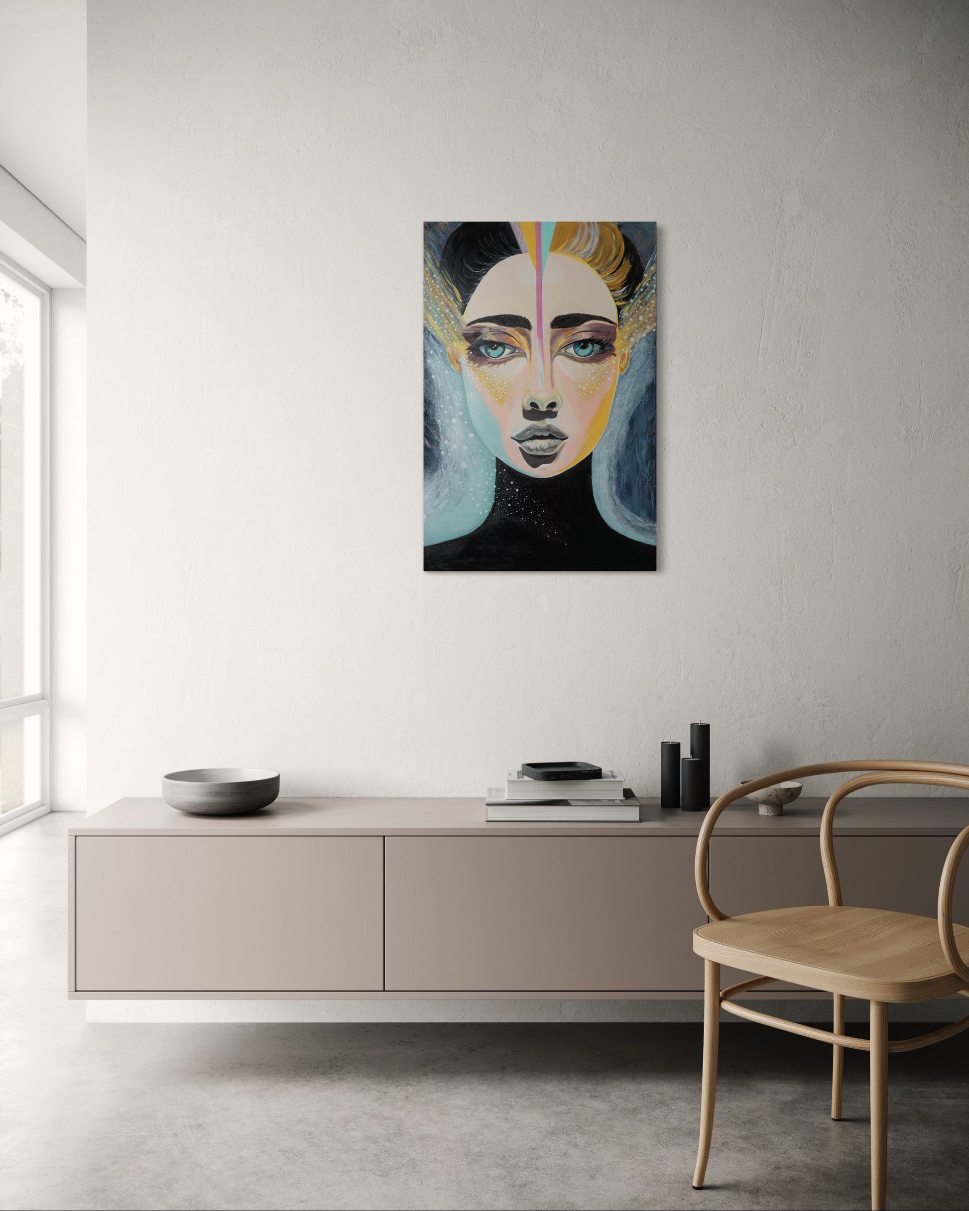 Abstract painting of a face on a wall in a modern interior setting.
