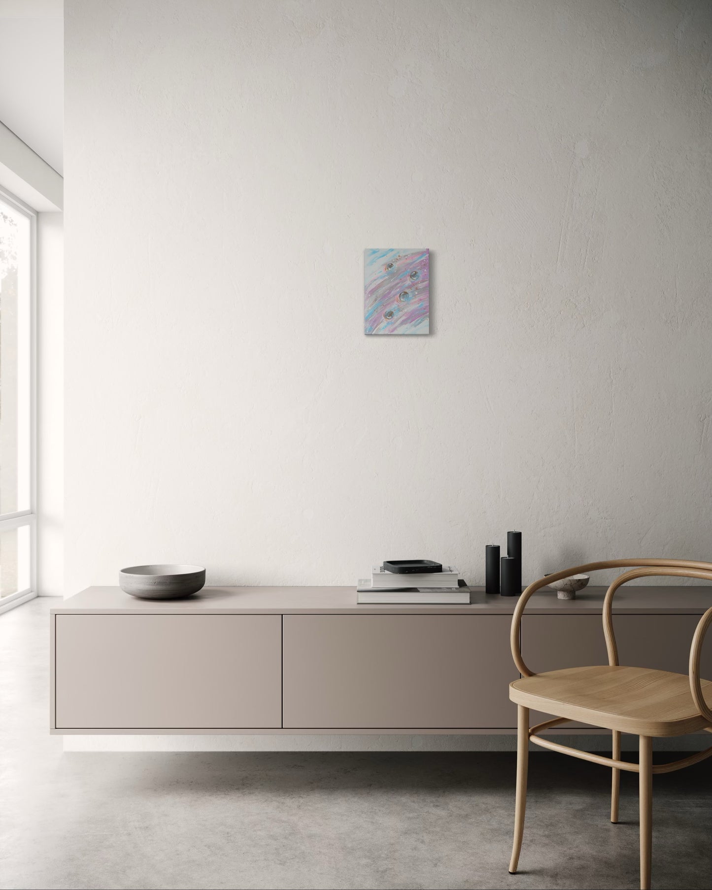 Modern interior with a light-colored cabinet, chair, and abstract painting on a white wall.