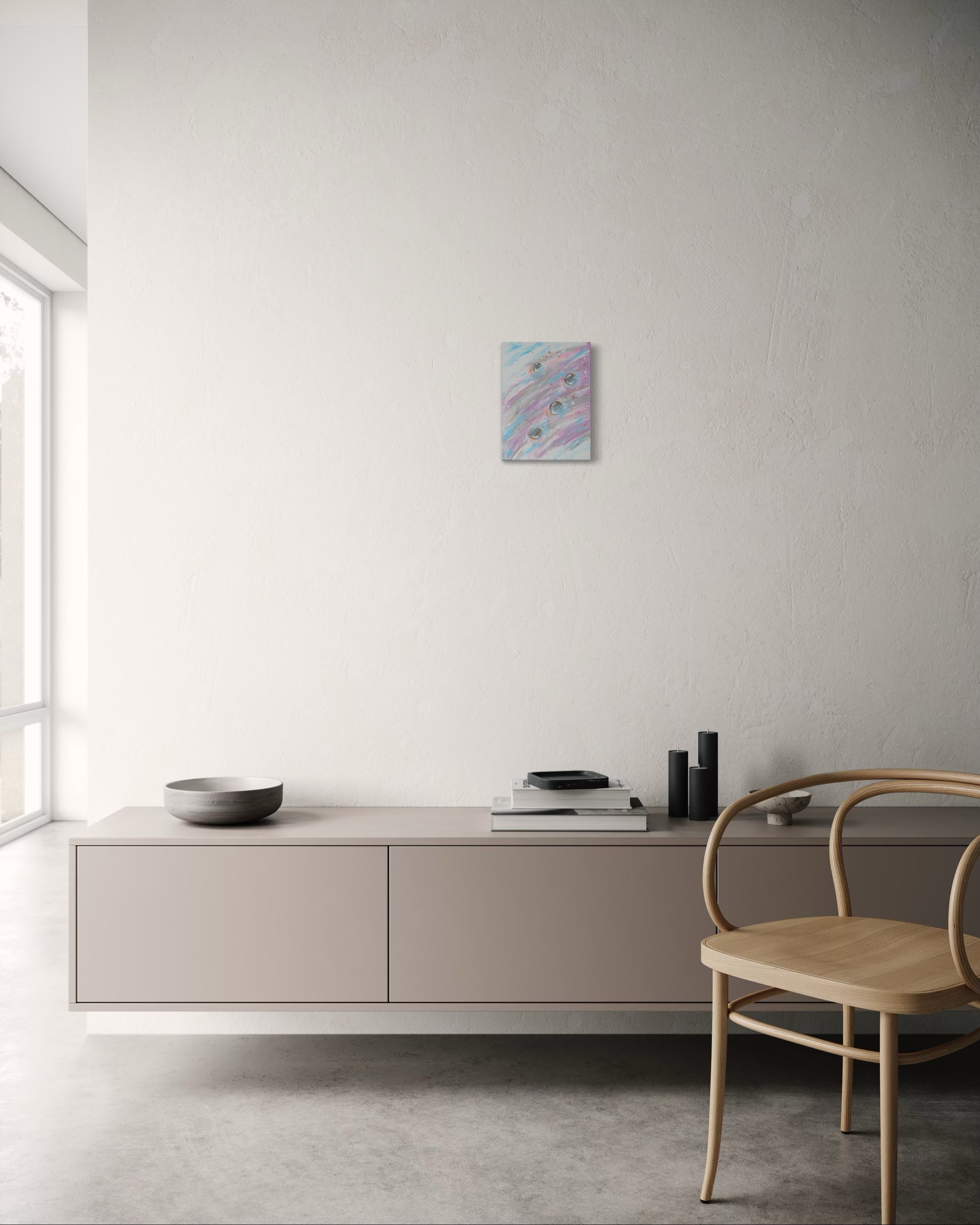 Modern interior with a light-colored cabinet, chair, and abstract painting on a white wall.