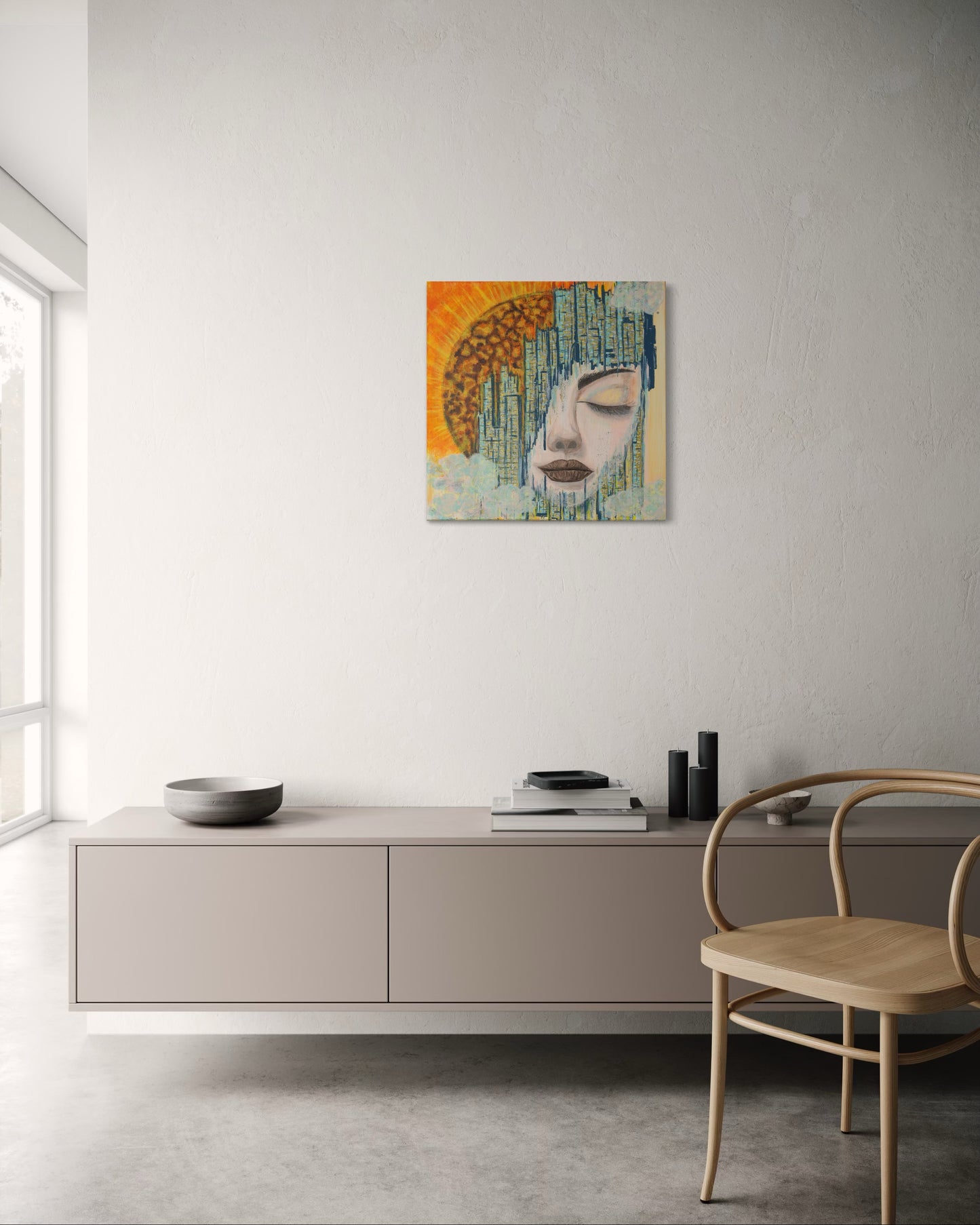 Modern interior with a painting of a woman's face on a wall above a cabinet.
